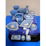 A tray of blue and white Wedgwood Jasperware trinket pots and dressing table items.