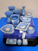 A tray of blue and white Wedgwood Jasperware trinket pots and dressing table items.