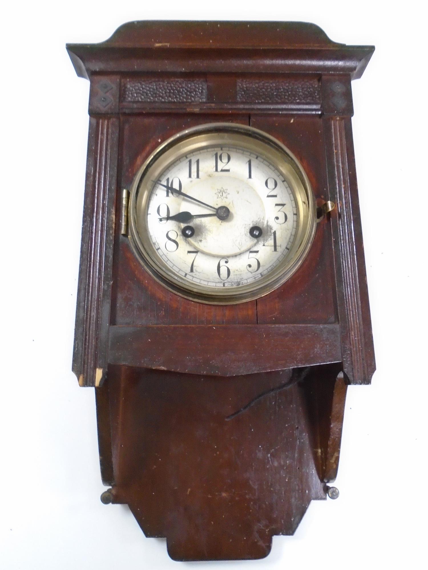 An Edwardian stained beech wall clock.