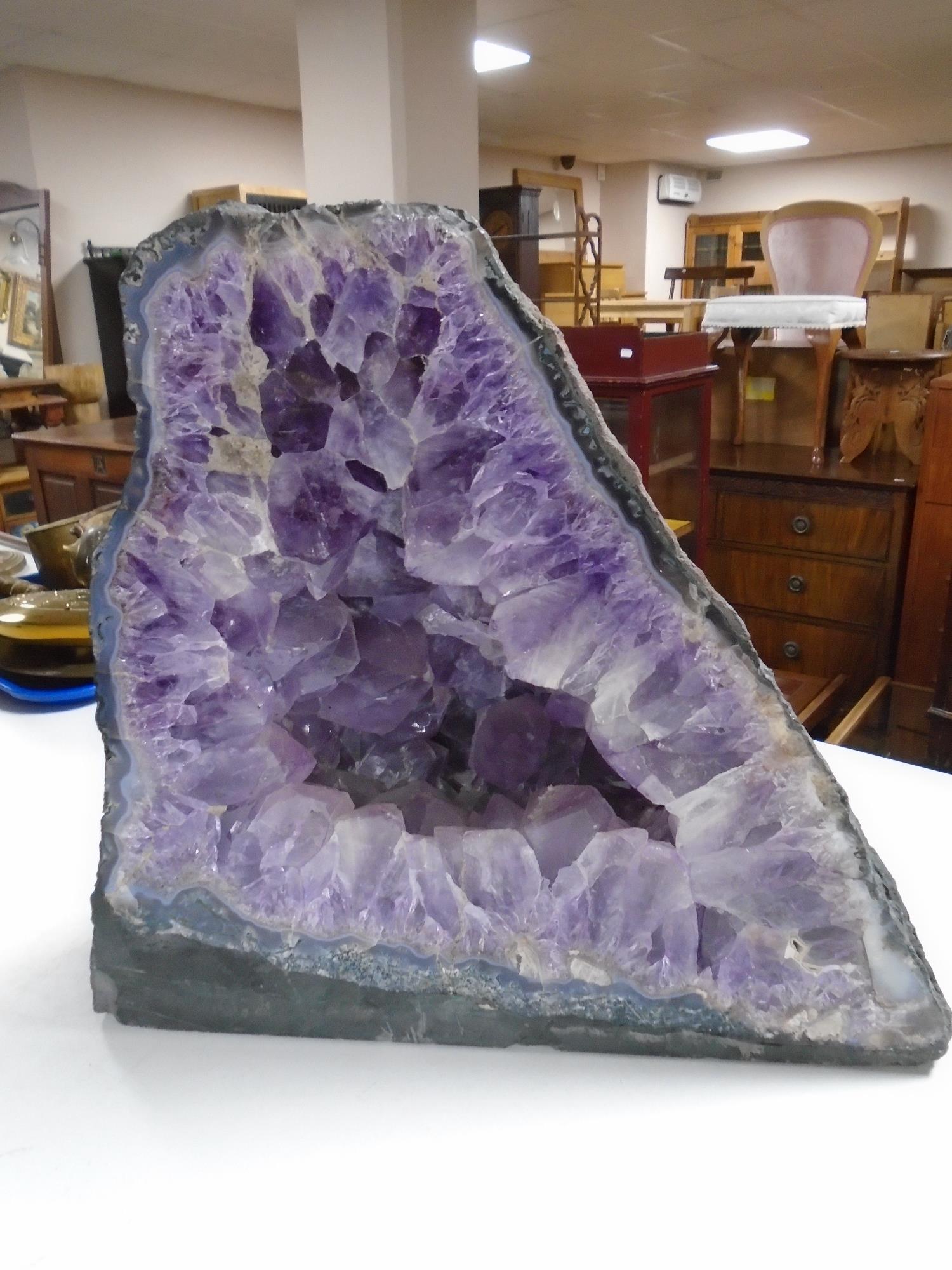 A large amethyst rock specimen, approximately 45 cm x 40 cm x 20 cm.