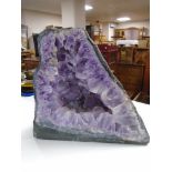 A large amethyst rock specimen, approximately 45 cm x 40 cm x 20 cm.