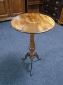 A 19th century mahogany pedestal wine table on metal legs.