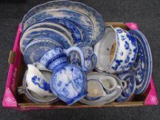 A box of blue and white china plates together with a blue and white jug.