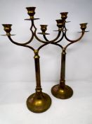 A pair of brass ecclesiastical style candle sticks.