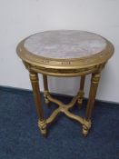 A gilt circular occasional table with inset marble top