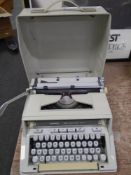 A Hermes 3000 manual typewriter in case.