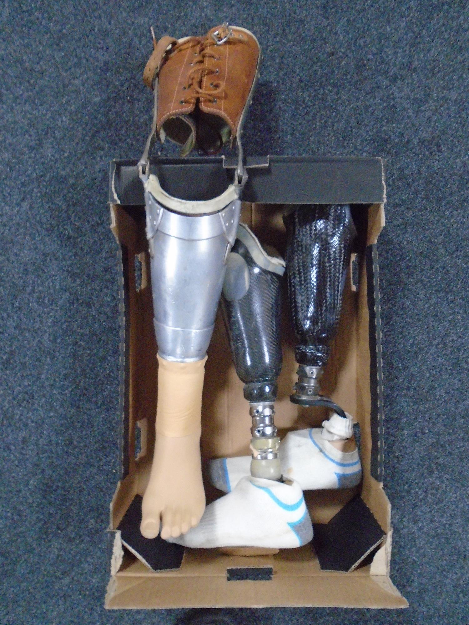 Three artificial lower limbs, two with carbon fibre components.