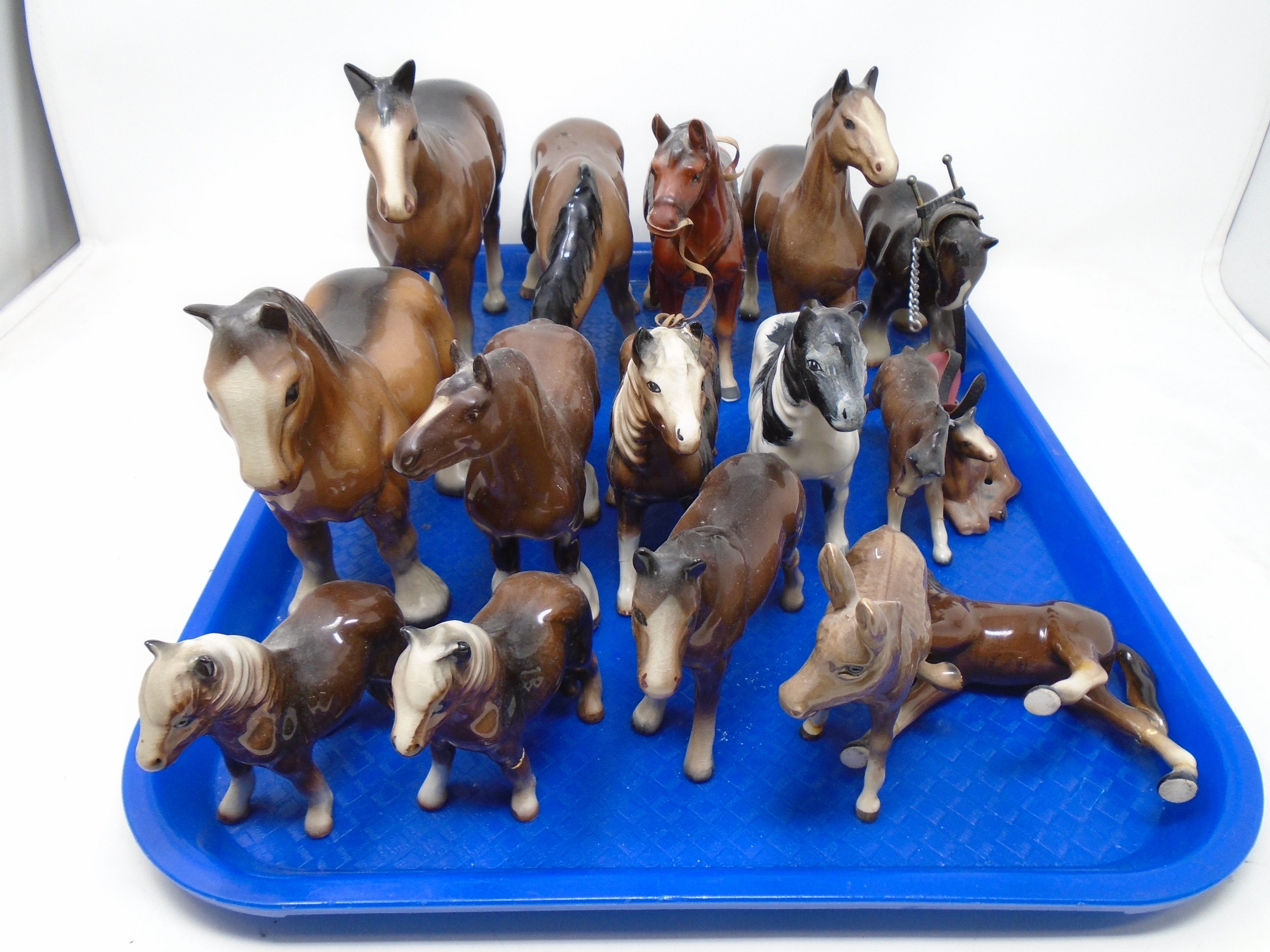 A tray of china horse figures, Beswick donkey etc.