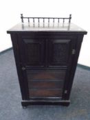 An Edwardian ebonised music cabinet