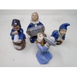 Four Royal Copenhagen figures of children with musical instruments.