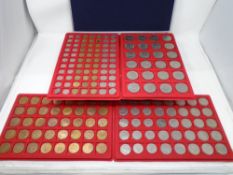 A case containing a large quantity of trays of coins, 20th century sixpence pieces,