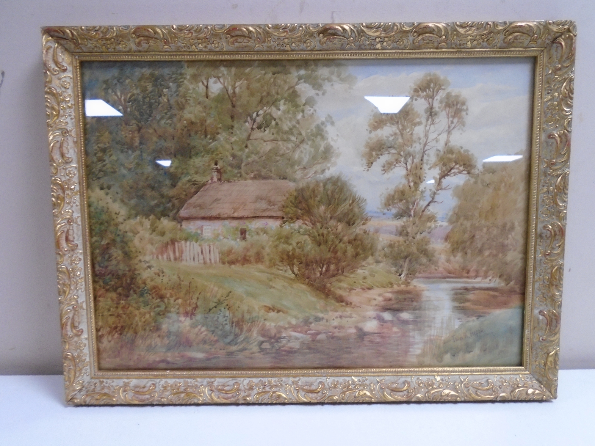 John Wilson Hepple : A thatched cottage by a river, watercolour, 37cm by 26cm.