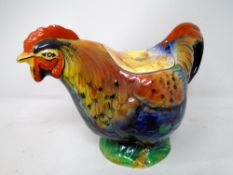 A vintage ceramic rooster teapot.