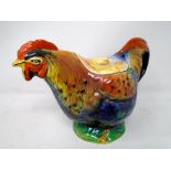 A vintage ceramic rooster teapot.