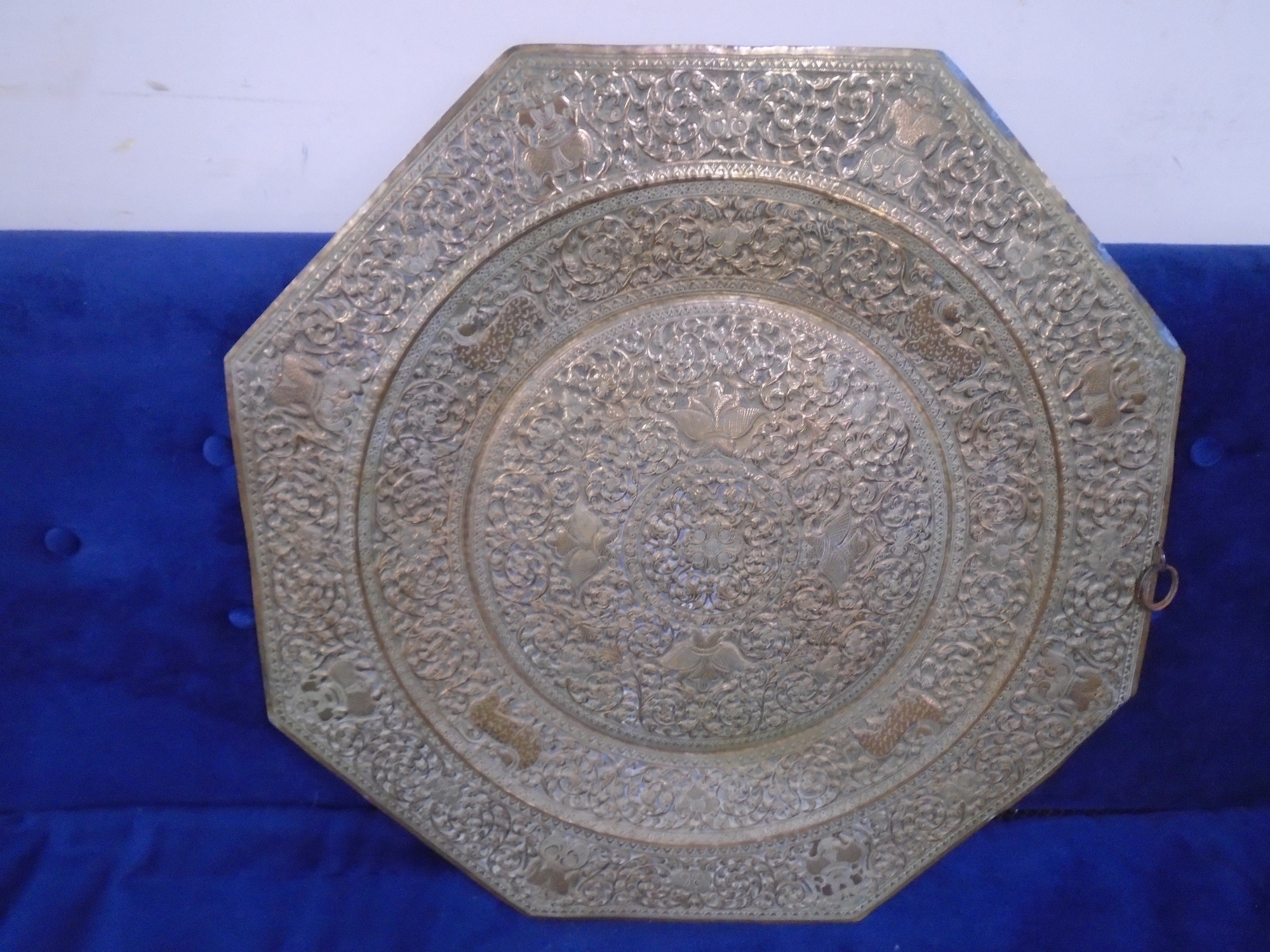 An eastern brass charger with embossed decoration (width 62cm).