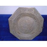An eastern brass charger with embossed decoration (width 62cm).