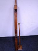 Two wooden pipes together with a hat stand.