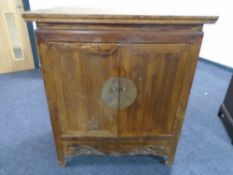 A Chinese elm double door cabinet