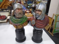 A pair of ornamental soldier figures on plinths.
