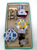 A box containing vintage AA and RAC badges, ACME whistles, Colibri and Firefly lighters.