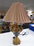 An ornate contemporary table lamp with shade.