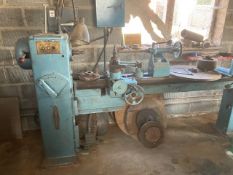 A mid 20th Century wood working lathe manufactured by Oliver with various parts and accessories