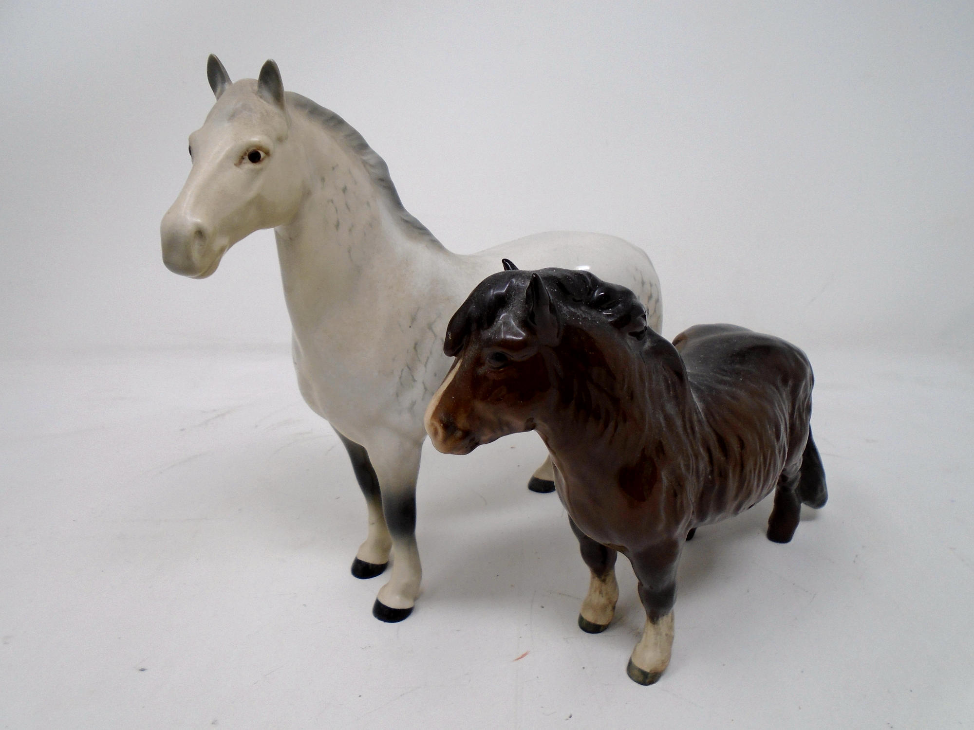 Two Beswick figures of a Shetland pony and a Grey Horse.