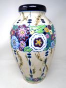 A Continental pottery vase decorated with multicoloured flowers.