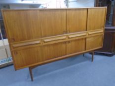 A mid-20th century teak Danish eight door high sideboard fitted with four drawers.