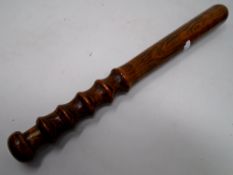 A turned-wooden truncheon.