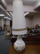 A Continental pottery table lamp with shade.