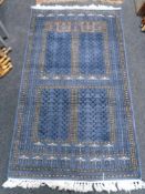 An Afghan Ensari-design rug on blue ground,