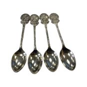 A set of four golf-themed silver teaspoons, Birmingham marks.