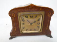 A 19th century French inlaid mahogany Art Nouveau desk clock.