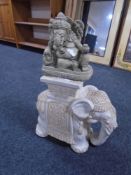 A ceramic elephant plant stand together with a pottery elephant figure.
