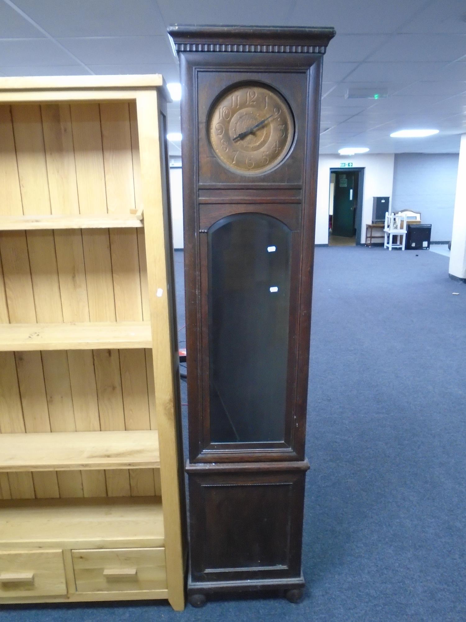 An oak longcase clock with metal dial.