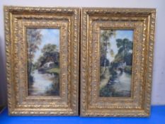 A pair of gilt frame oil-on-canvasses depicting swans on a lake.