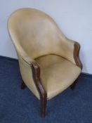 An Edwardian mahogany leather upholstered tub chair