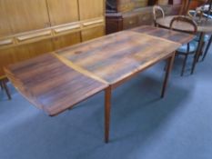 A mid-20th century rectangular rosewood extending dining table.