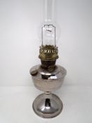 A 20th century chrome plated oil lamp with glass chimney.