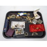 A tray containing assorted costume jewellery including filigree brooch, earrings, dress rings,