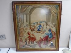 A Victorian tapestry in rosewood frame depicting figures around a table, 66cm by 72cm.