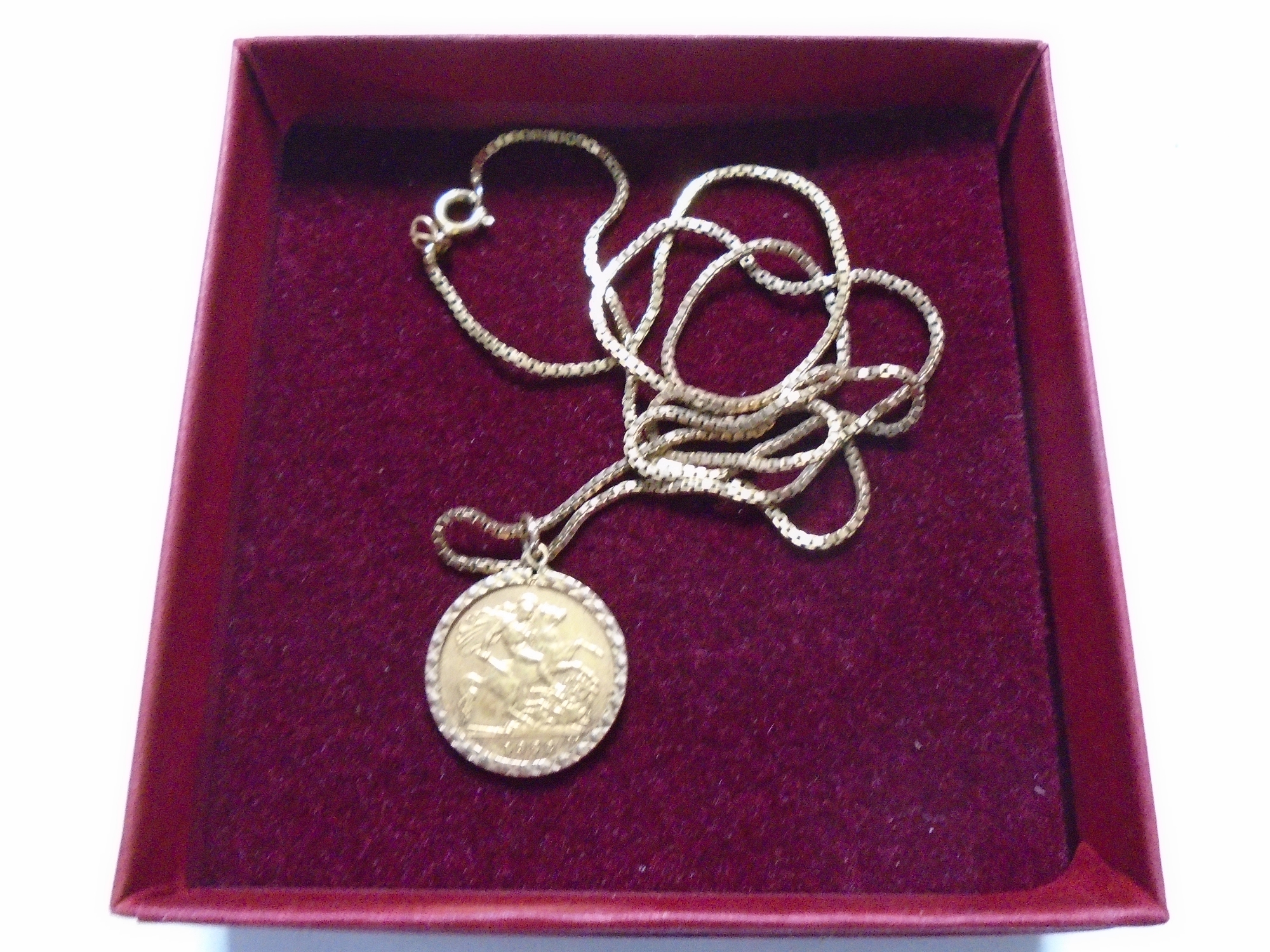 A 1982 half sovereign in mount on a 9ct gold chain.