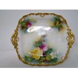 A Royal Worcester gilded twin handled dish decorated with roses.