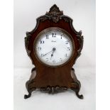 A walnut mantel clock with metal mounts signed Reid.