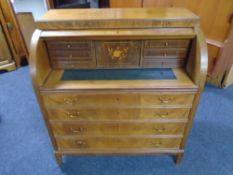 A mahogany barrel fronted bureau fitted with four drawers