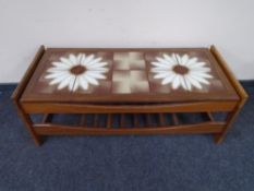 A 20th century teak tiled coffee table with under shelf