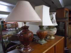 Three continental table lamps with shades.