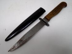 A trench knife in metal sheath, total length 26.4 cm.