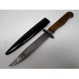 A trench knife in metal sheath, total length 26.4 cm.